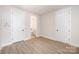 Bedroom featuring wood-look floors, two closets, and an ensuite bathroom at 212 Mattoon St, Charlotte, NC 28216