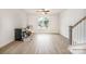 Bright living room featuring hardwood floors, a ceiling fan, and a staircase with white risers and a gray handrail at 212 Mattoon St, Charlotte, NC 28216
