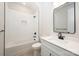Bathroom features a vanity with white countertops and a tiled shower/tub combo at 216 Mattoon St, Charlotte, NC 28216