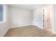 Bedroom with hardwood floors, white walls, trim, and a large window at 216 Mattoon St, Charlotte, NC 28216