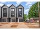 Modern townhome featuring a sleek gray exterior, dark trim, and a stylish garage door at 216 Mattoon St, Charlotte, NC 28216