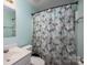 Bathroom featuring a decorative shower curtain, sink, and toilet at 219 E Boston Ave # 141516, Bessemer City, NC 28016