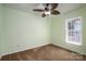 Cozy bedroom with green paneled walls, carpet flooring, and a ceiling fan at 219 E Boston Ave # 141516, Bessemer City, NC 28016