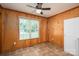 Bright dining area with wood paneled walls, tile flooring, and large window at 219 E Boston Ave # 141516, Bessemer City, NC 28016