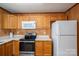 Cozy kitchen featuring wood paneling, ample cabinet space, and modern appliances at 219 E Boston Ave # 141516, Bessemer City, NC 28016