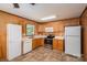 Kitchen with wood cabinets, tile flooring, and modern appliances at 219 E Boston Ave # 141516, Bessemer City, NC 28016