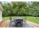 Backyard exterior featuring a table, chairs, and a patio area at 220 Low Water Bridge Rd, Troy, NC 27371