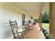 Spacious front porch with rocking chairs, perfect for enjoying a relaxing afternoon outdoors at 220 Low Water Bridge Rd, Troy, NC 27371