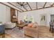 Spacious living room with exposed beams, fireplace, hardwood floors, and natural light at 220 Low Water Bridge Rd, Troy, NC 27371