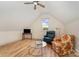 Cozy sitting room loft featuring wood floors, television, and chairs at 220 Low Water Bridge Rd, Troy, NC 27371
