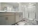 Bright bathroom showcasing double sinks, a large mirror, and glass enclosed shower for a spa-like experience at 2282 Redstone Dr, York, SC 29745
