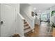 Entryway view featuring carpeted stairs, hardwood floors, and a glimpse into the kitchen at 2282 Redstone Dr, York, SC 29745