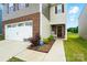 Exterior side view showcasing the brick and siding details, front door and walkway at 2282 Redstone Dr, York, SC 29745