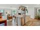 Open kitchen with a center island, stainless steel appliances, and an adjoining living room at 2282 Redstone Dr, York, SC 29745