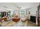 Bright and airy living room with a fireplace, ceiling fan, and large windows for natural light at 2282 Redstone Dr, York, SC 29745