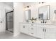 Modern bathroom with dual sinks, sleek mirrors, and glass-enclosed shower at 2818 Old Steele Creek Rd, Charlotte, NC 28208