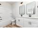 Stylish bathroom features double sinks and a tub with white cabinets at 2818 Old Steele Creek Rd, Charlotte, NC 28208