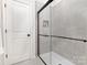 Contemporary shower with glass doors, modern fixtures, and tiled walls at 2818 Old Steele Creek Rd, Charlotte, NC 28208