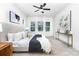 Bright main bedroom with large windows, neutral decor, and a ceiling fan at 2818 Old Steele Creek Rd, Charlotte, NC 28208