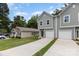New construction home with an attached garage and long driveway on a sunny day at 2818 Old Steele Creek Rd, Charlotte, NC 28208