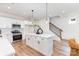 Modern kitchen featuring an island with pendant lights, white cabinets, and stainless steel appliances at 2818 Old Steele Creek Rd, Charlotte, NC 28208