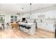 Contemporary kitchen with white cabinetry, stainless steel appliances, and center island with barstool seating at 2818 Old Steele Creek Rd, Charlotte, NC 28208
