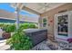 Relaxing covered porch with a hot tub, ceiling fan, and view of the lush backyard at 282 Harrison Ln, Locust, NC 28097