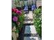Beautiful backyard garden with a stone paver path leading to outdoor seating and lovely pink flowers at 282 Harrison Ln, Locust, NC 28097