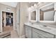 Modern bathroom featuring a double vanity, walk-in closet, and contemporary lighting fixtures for a sleek look at 282 Harrison Ln, Locust, NC 28097