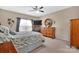 Comfortable bedroom with ceiling fan, dresser, and large window allowing natural light to fill the room at 282 Harrison Ln, Locust, NC 28097
