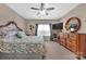 Spacious bedroom with ceiling fan, dresser, and large window providing plenty of natural light at 282 Harrison Ln, Locust, NC 28097