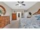 Inviting bedroom featuring a ceiling fan, dresser, and walk-in closet providing ample storage space at 282 Harrison Ln, Locust, NC 28097