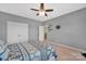 Comfortable bedroom with a ceiling fan, large window, and bed with stylish bedding at 282 Harrison Ln, Locust, NC 28097