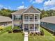 Charming two-story home featuring a welcoming porch and a well-manicured front yard at 282 Harrison Ln, Locust, NC 28097