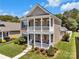 Charming two-story home featuring a welcoming porch and a well-manicured front yard at 282 Harrison Ln, Locust, NC 28097