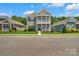 Inviting two-story home with a double porch, landscaped front yard, and a welcoming facade at 282 Harrison Ln, Locust, NC 28097