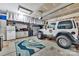Organized garage featuring a jeep, storage cabinets, and a clean, functional workspace at 282 Harrison Ln, Locust, NC 28097