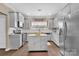 Modern kitchen featuring stainless steel appliances, gray cabinetry, and an island at 282 Harrison Ln, Locust, NC 28097