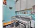 Well-equipped laundry room with stainless steel washer and dryer, along with upper cabinets for ample storage at 282 Harrison Ln, Locust, NC 28097