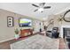 Open-concept living room with a fireplace, ceiling fan, and staircase access to the upper level at 282 Harrison Ln, Locust, NC 28097