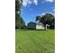 A sprawling green lawn surrounds a cozy home with a detached garage at 28518 Flint Ridge Rd, Albemarle, NC 28001