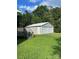 Two-car detached garage near wooden deck stairs, situated on a lush green lawn at 28518 Flint Ridge Rd, Albemarle, NC 28001