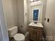 Powder room with a modern vanity, toilet, and mirror creates a compact and stylish space at 3824 Freedom Dr, Charlotte, NC 28208