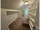 Spacious closet with shelves, rod, and a mirror offers ample storage space for clothing and accessories at 3824 Freedom Dr, Charlotte, NC 28208