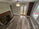 Clean, open dining area featuring wood-look flooring, a brick fireplace, built-in bookcase and a ceiling fan at 3824 Freedom Dr, Charlotte, NC 28208