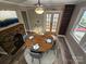 Inviting dining room featuring a round wood table, a brick fireplace, built-in bookcase and a stylish ceiling fan at 3824 Freedom Dr, Charlotte, NC 28208