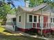 Well-maintained home with a covered porch, freshly painted exterior, complemented by a spacious yard at 3824 Freedom Dr, Charlotte, NC 28208