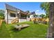 Beautiful backyard featuring a fire pit with Adirondack chairs, lush grass, and exterior view of the home at 3949 Plainview Rd, Charlotte, NC 28208