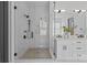 Modern bathroom featuring a glass-enclosed shower and double vanity with sleek fixtures and bright lighting at 3949 Plainview Rd, Charlotte, NC 28208