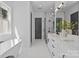 Spacious bathroom with tub, glass shower, double vanity, and marble floors for a luxurious feel at 3949 Plainview Rd, Charlotte, NC 28208